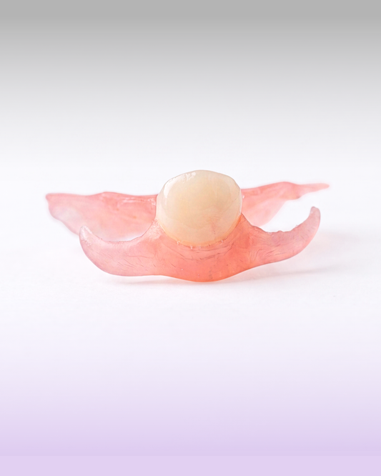 A flexible flipper partial denture for a missing upper tooth, presented on a purple gradient background